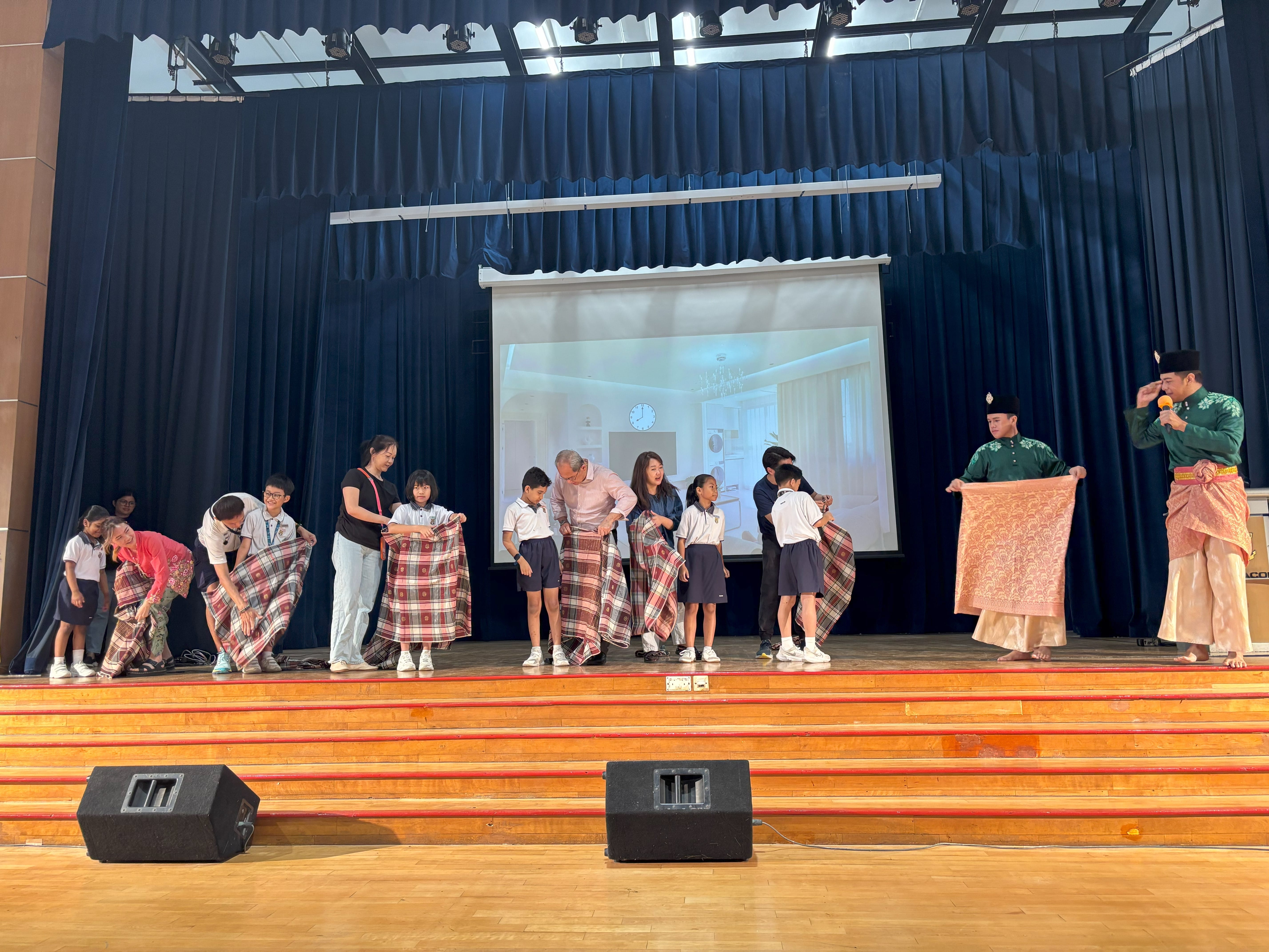 Teachers and students trying on Samping